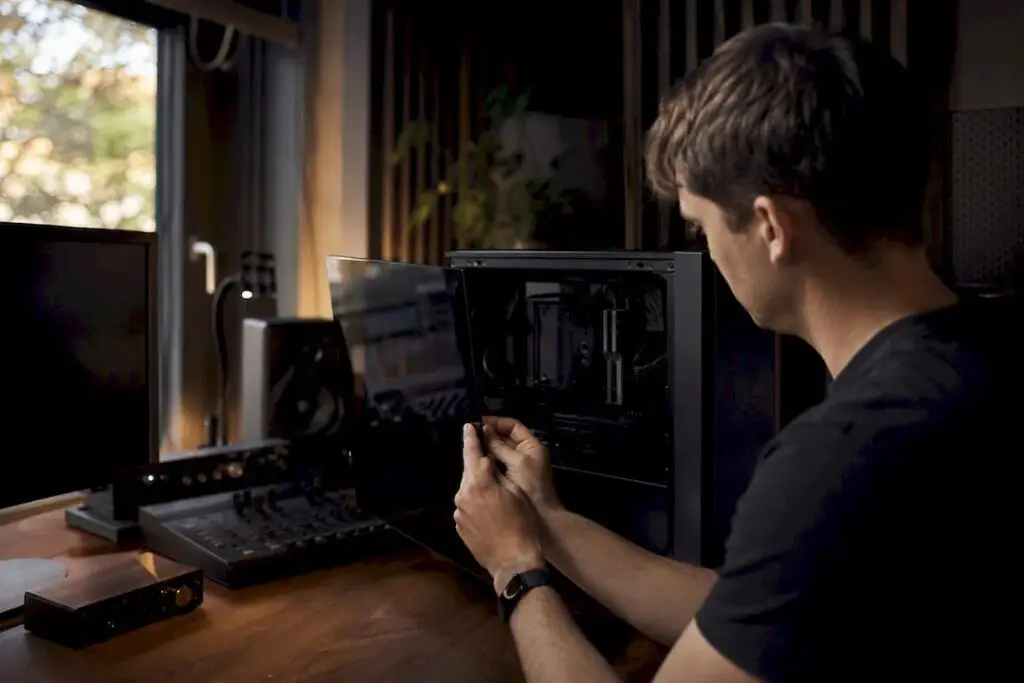 Iemand start zijn studio-pc op om problemen met de plugins op te lossen.